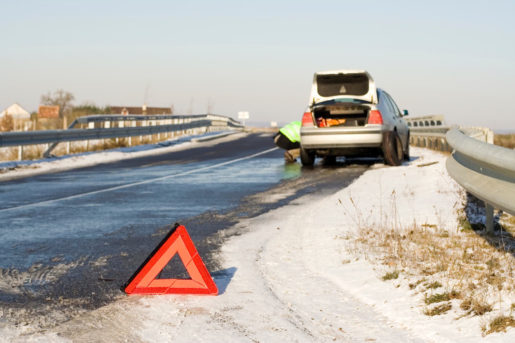 car stranded on side of road in winter