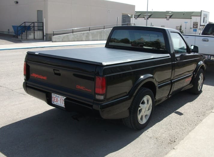 rear view of a black Syclone parked in a warehouse district