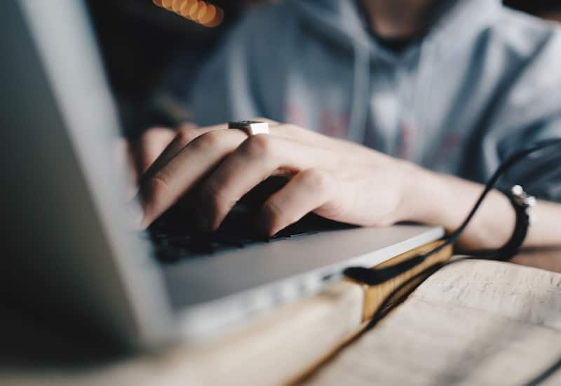 man typing on computer