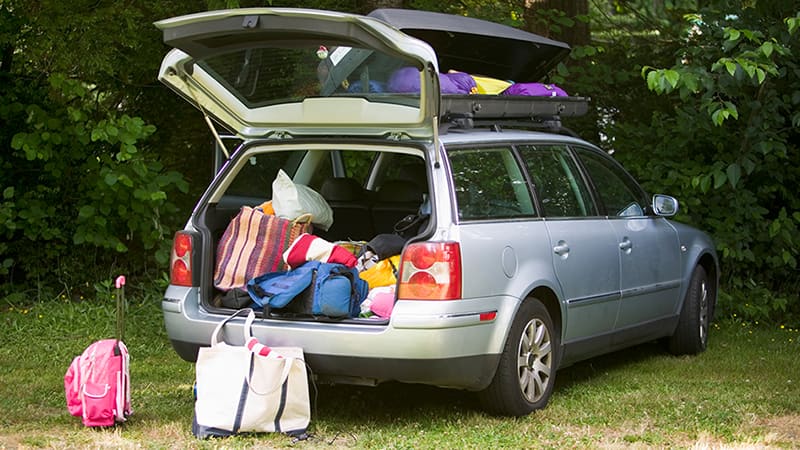 A silver car filled with cargo.