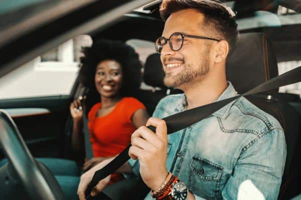 Driver putting on seatbelt