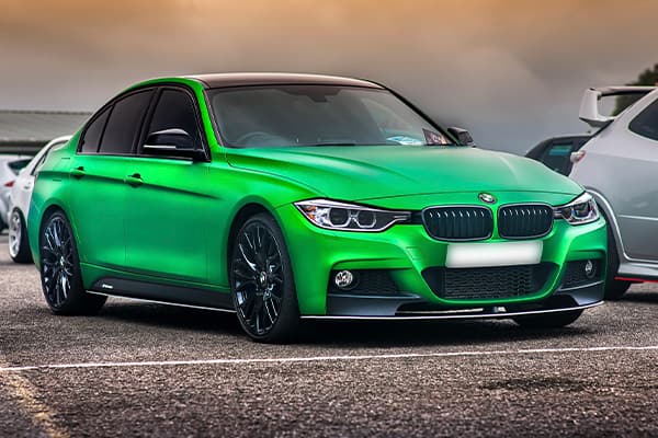 wrapped green BMW 3 Series with tinted windows and black wheels | Source: J Morris via Pixabay